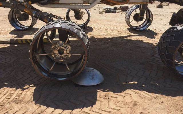 A "scarecrow" rover at NASA's JPL drives over a sensor while testing a new driving algorithm. Engineers created the algorithm to reduce wheel wear on the Mars Curiosity rover.