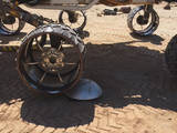 A "scarecrow" rover at NASA's JPL drives over a sensor while testing a new driving algorithm. Engineers created the algorithm to reduce wheel wear on the Mars Curiosity rover.