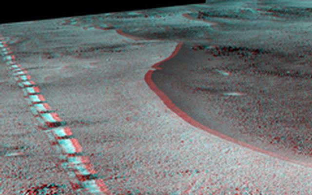 This view of a 90-foot-wide, relatively fresh crater on Mars, "Orion Crater," combines images from the left eye and right eye of the Panoramic Camera (Pancam) on NASA's Mars Exploration Rover Opportunity. It appears three-dimensional when seen through blue-red glasses with the red lens on the left.