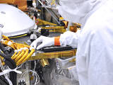 An engineer in the clean room at Lockheed Martin Space in Littleton, Colorado, affixes a dime-size chip onto the lander deck of NASA's InSight spacecraft.