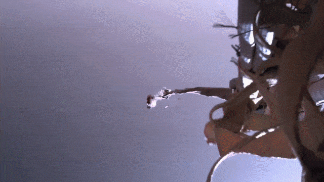 A top-down view shows the Perseverance rover dangling on cables, moments before touchdown on Mars.