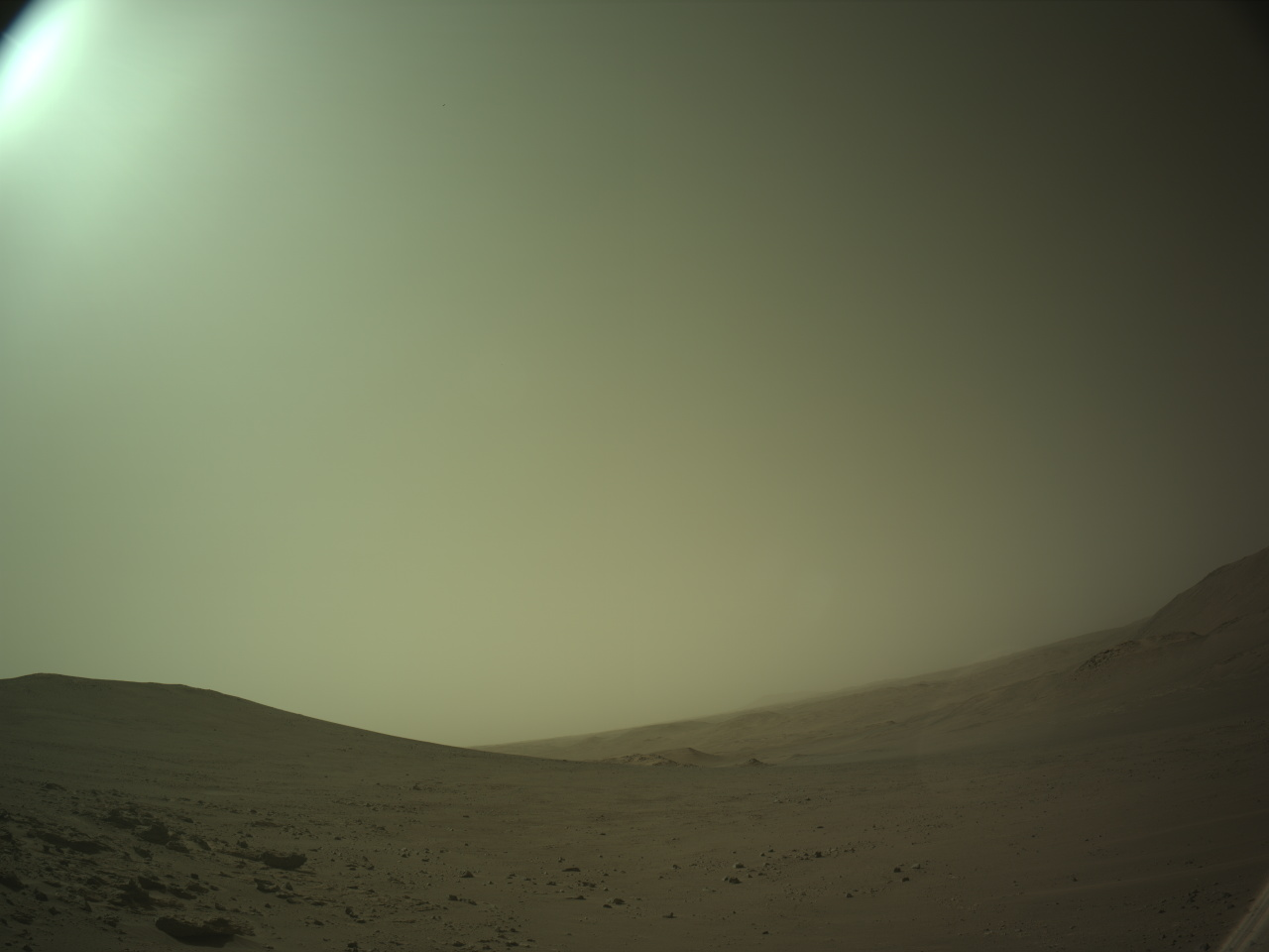 NASA's Mars Perseverance rover acquired this image using its onboard Left Navigation Camera (Navcam). The camera is located high on the rover's mast and aids in driving. 

This image was acquired on June 7, 2026 (Sol 1883) at the local mean solar time of 11:42:07.