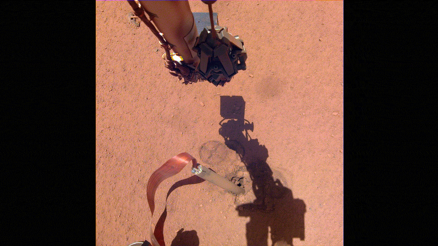 slide 4 - The shadow of NASA InSight's robotic arm moves over its heat probe, or "mole," on Nov. 3, 2019, the 333rd Martian day, or sol, of the mission. 