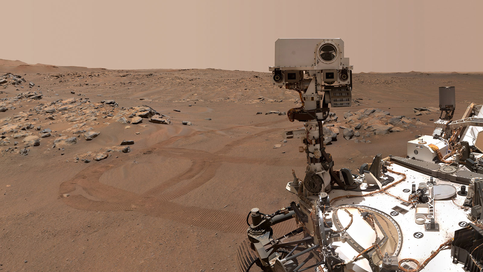 slide 2 - Perseverance Mars rover took a selfie over a rock with two holes where the rover used its robotic arm to drill rock core samples.