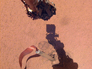 The shadow of NASA InSight's robotic arm moves over its heat probe, or "mole," on Nov. 3, 2019, the 333rd Martian day, or sol, of the mission.