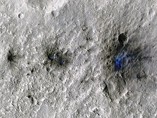 These craters were formed by a Sept. 5, 2021, meteoroid impact on Mars, the first to be detected by NASA’s InSight. Taken by NASA’s Mars Reconnaissance Orbiter, this enhanced-color image highlights the dust and soil disturbed by the impact in blue in order to make details more visible to the human eye.