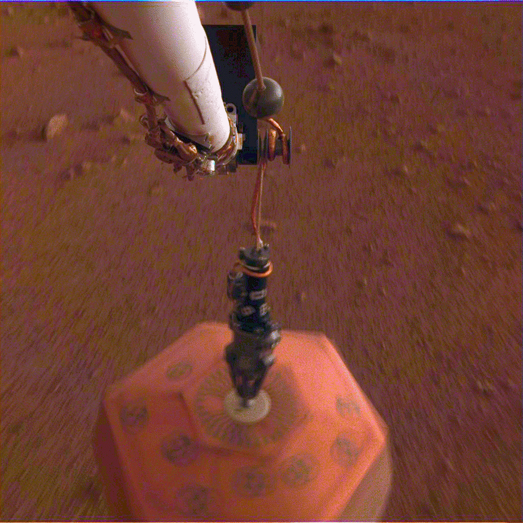 This set of images from the Instrument Deployment Camera shows NASA&#39;s InSight lander placing its first instrument onto the surface of Mars, completing a major mission milestone. Image Credit: NASA/JPL-Caltech.&nbsp;Full image and caption.