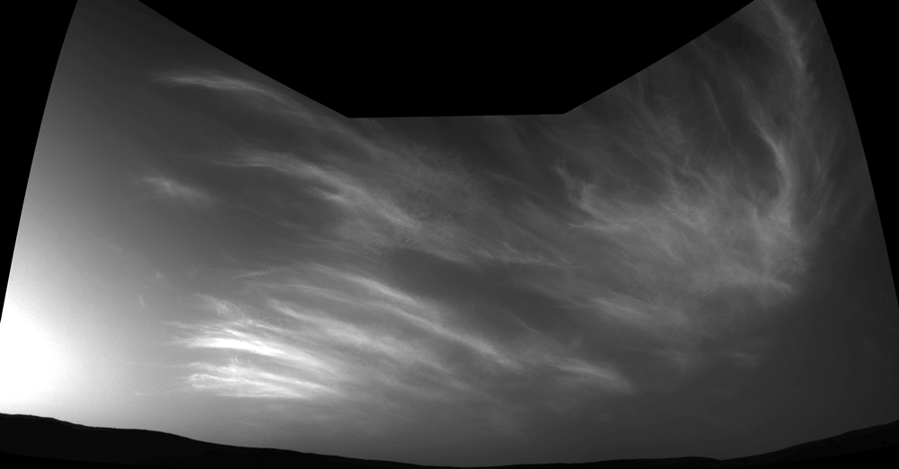 NASA's Curiosity Mars rover imaged these drifting clouds on May 17, 2019, the 2,410th Martian day, or sol, of the mission, using its black-and-white Navigation Cameras (Navcams).