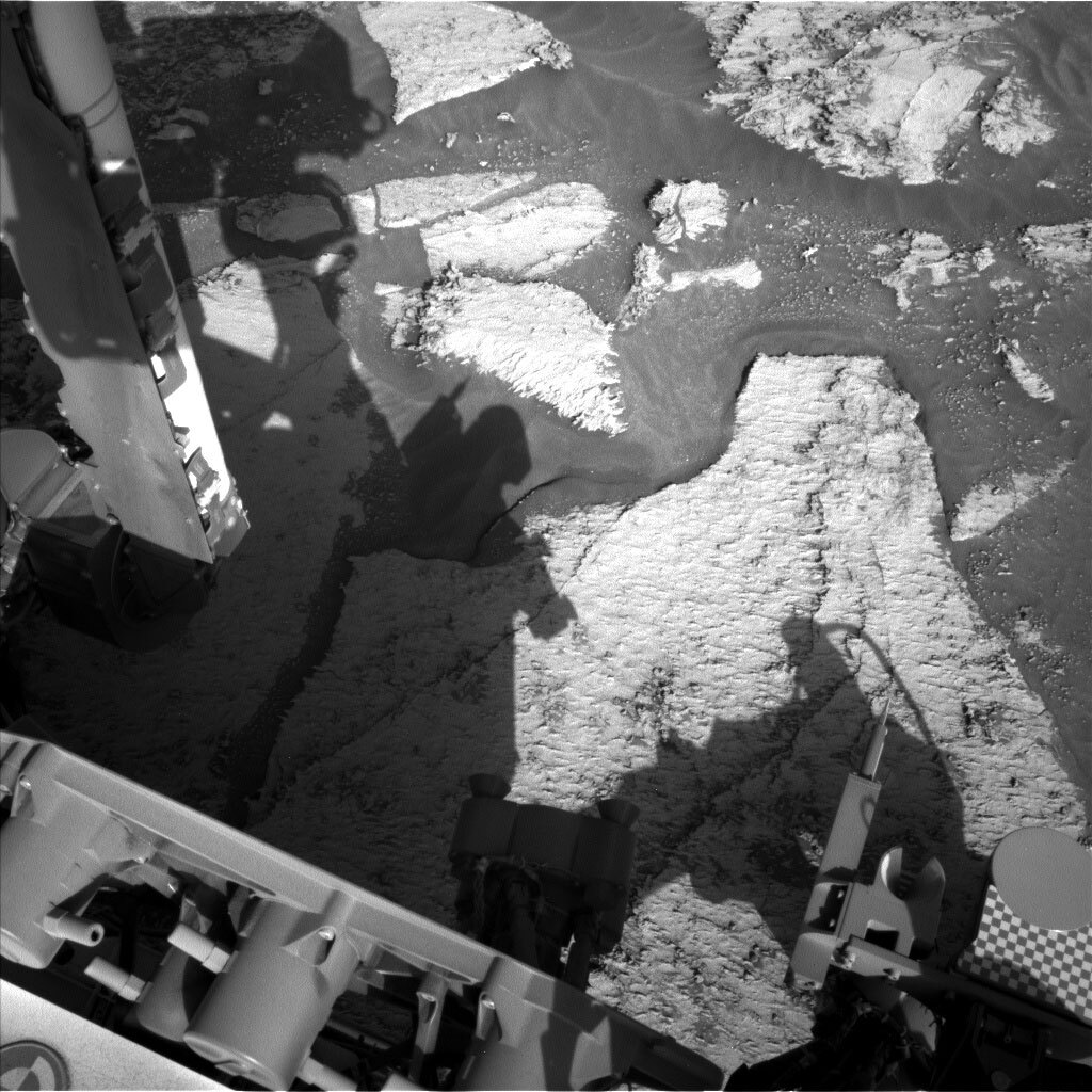 This black and white image was taken by Left Navigation Camera onboard NASA's Mars rover Curiosity on Sol 3165 and it captures the rocky surface of Mars.