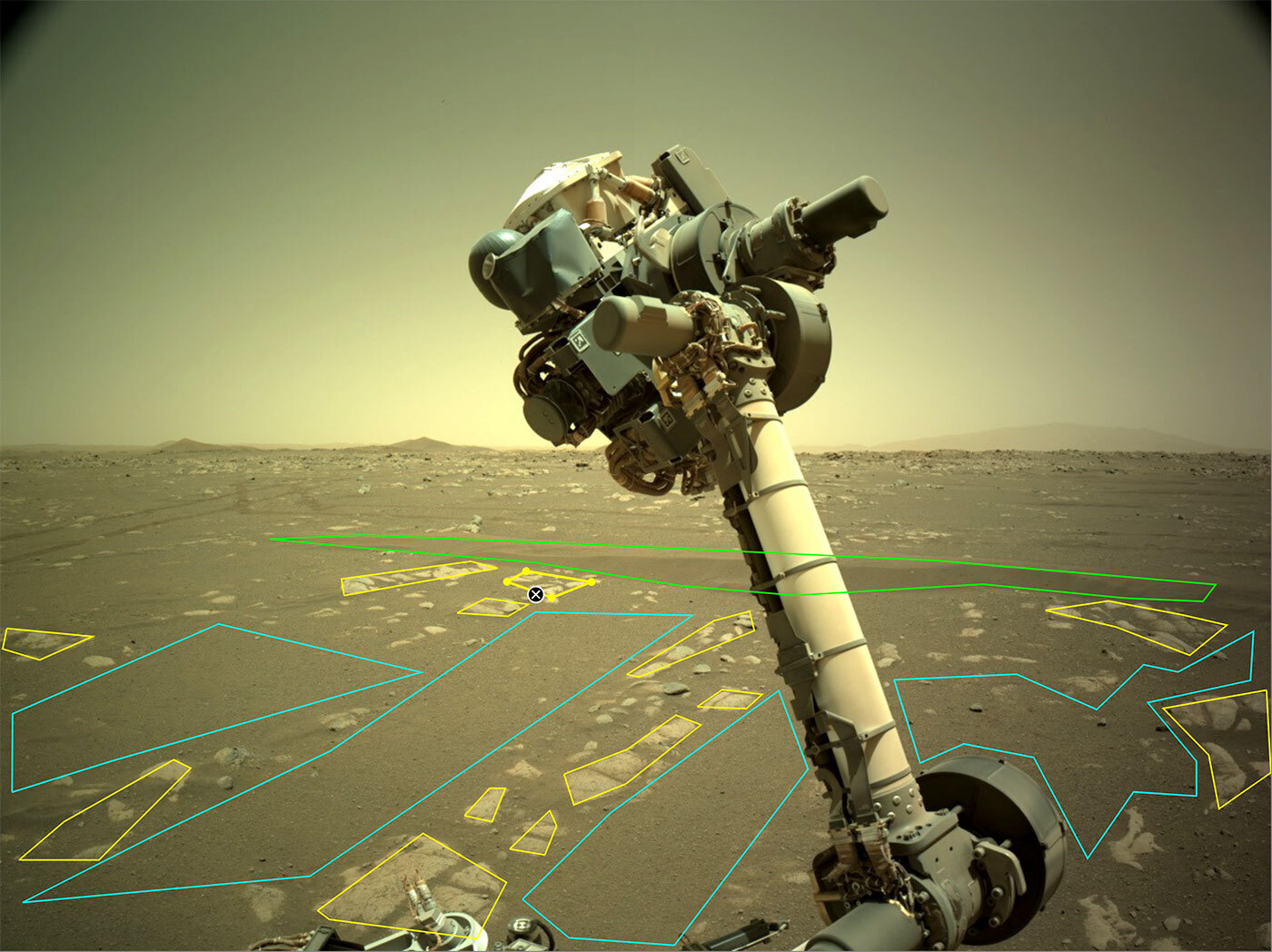 This is an image of the robotic arm of NASA’s Perseverance rover. The image is annotated by outlining on particular rocks on the surface. Users outline and identify different rock and landscape features to help train an artificial intelligence algorithm that will help improve the capabilities of Mars rovers.
