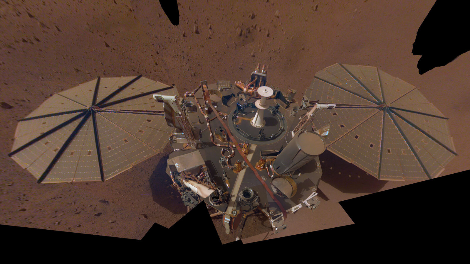 This is NASA InSight's second full selfie on Mars. Since taking its first selfie, the lander has removed its heat probe and seismometer from its deck, placing them on the Martian surface; a thin coating of dust now covers the spacecraft as well.