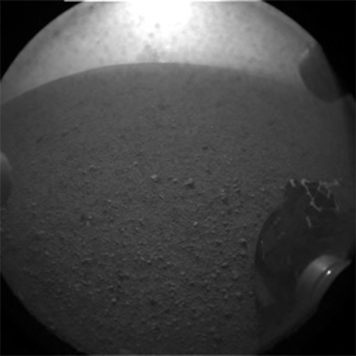 This image was taken by the Rear Hazard Avoidance Camera (Rear Hazcam) onboard NASA's Mars rover Curiosity on Sol 0 (2012-08-06 05:18:38 UTC) with the dust cover still on the camera, and the right image was taken by the Rear Hazard Avoidance Camera (Rear Hazcam) onboard NASA's Mars rover Curiosity on Sol 3553 (2022-08-04 21:34:03 UTC) and thus the newest one available today.