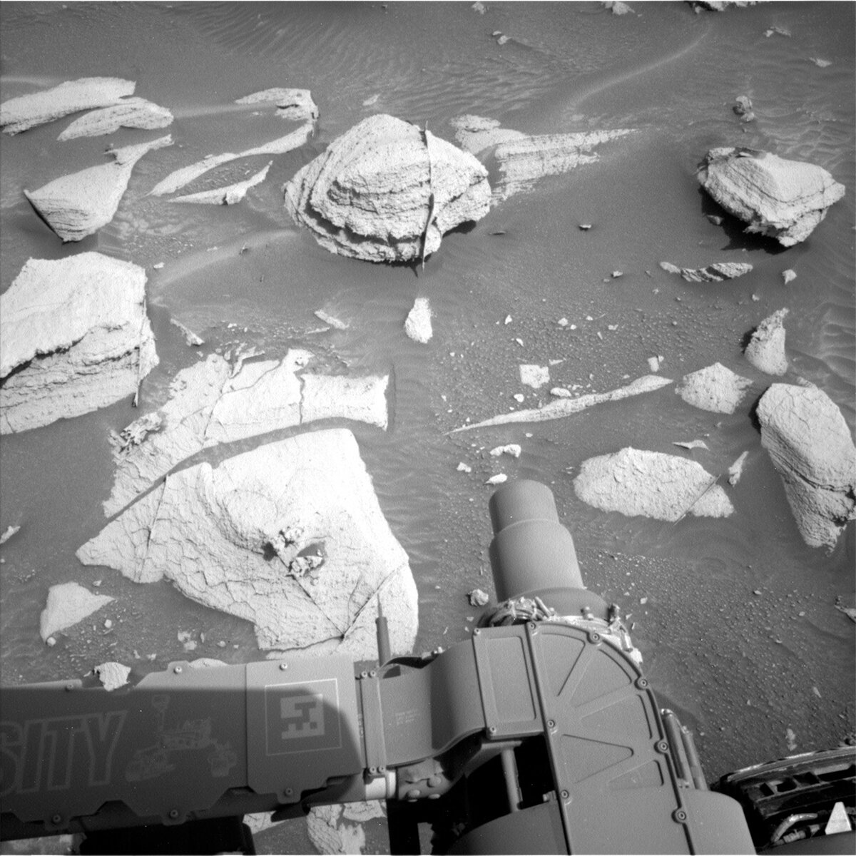 Navcam left image of the current workspace. The block immediately in front of the rover (slightly left of centre) is the focus for many of our observations in this plan.