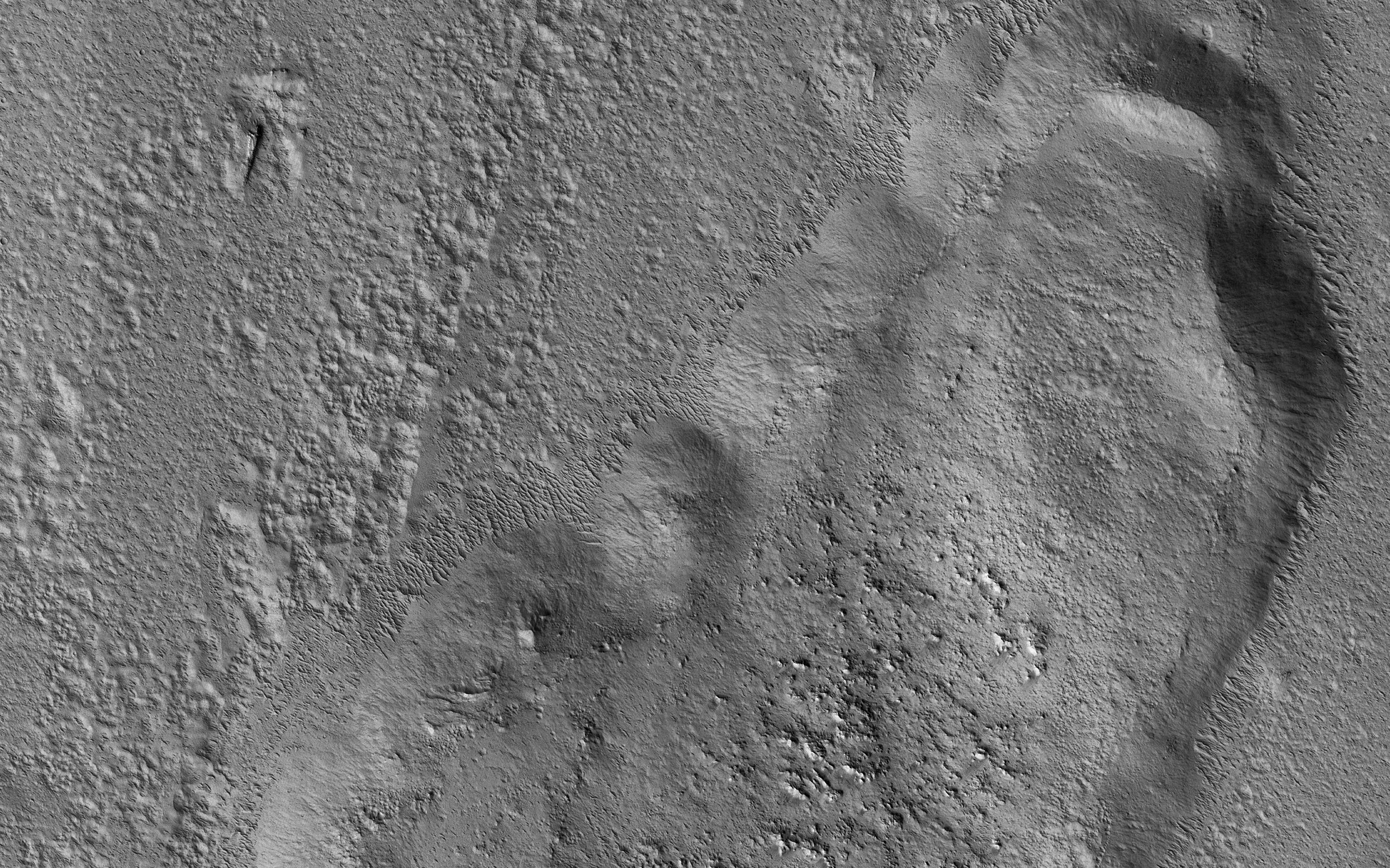This image acquired on September 24, 2018 by NASAs Mars Reconnaissance Orbiter, shows a huge tongue-like form, which looks a like a mudflow with boulders on its surface.