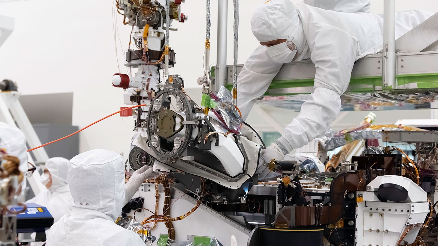 In this August 5, 2019 image, the bit carousel - the heart of sampling and caching subsystem of NASA’s Mars 2020 mission -  is attached to the front end of the rover.