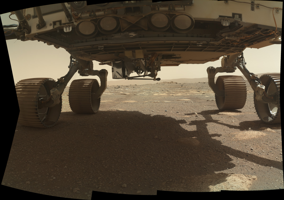 Ingenuity helicopter under the belly of the Perseverance rover on the Mars' surface