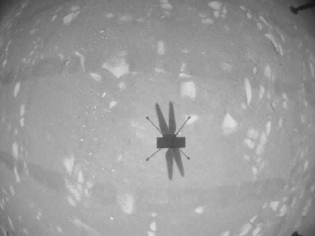 The Ingenuity Mars Helicopter’s navigation camera captures the helicopter’s shadow on the surface of Jezero Crater during rotorcraft’s second experimental test flight on April 22, 2021. 