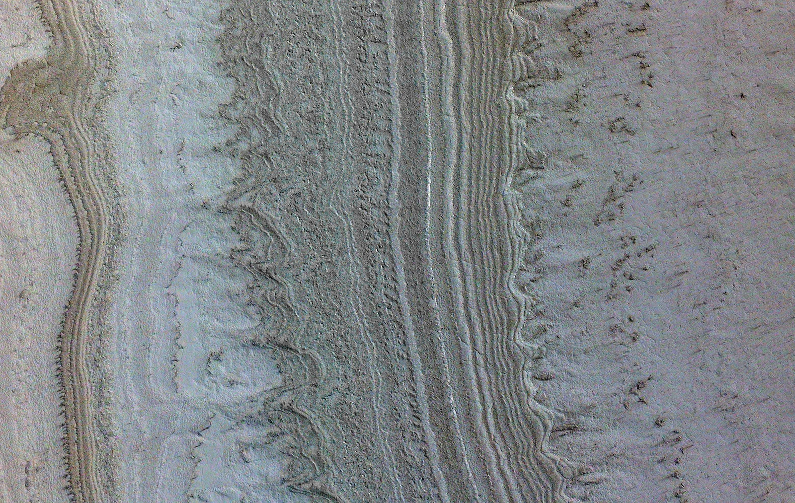 This image taken by NASA’s Mars Reconnaissance Orbiter shows ice sheets at Mars’ south pole. The spacecraft detected clays nearby this ice; scientists have proposed such clays are the source of radar reflections that have been previously interpreted as liquid water.