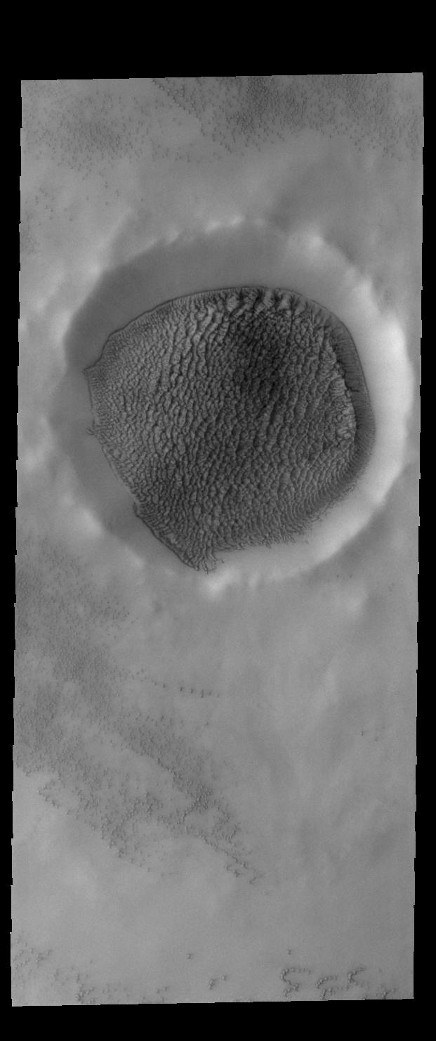 This image from NASAs Mars Odyssey shows an unnamed crater in the northern plains of Mars.