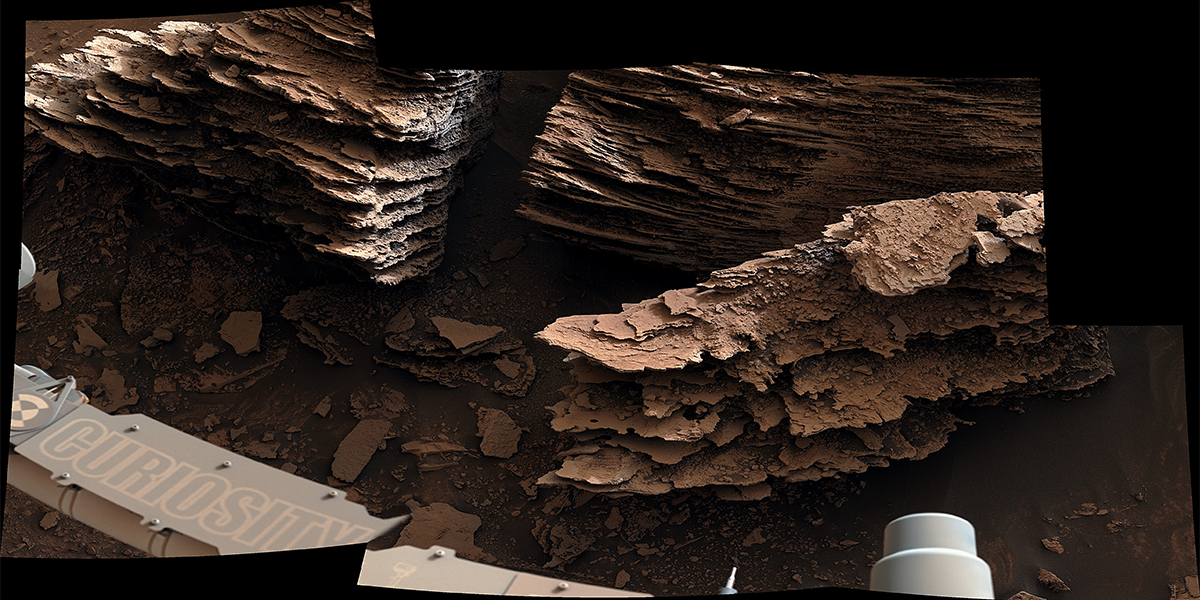 NASA’s Curiosity Mars rover captured this view of layered, flaky rocks believed to have formed in an ancient streambed or small pond – the six images that make up this mosaic were captured using Curiosity’s Mast Camera, or Mastcam, on June 2, 2022, the 3,492nd Martian day, or sol, of the mission.
