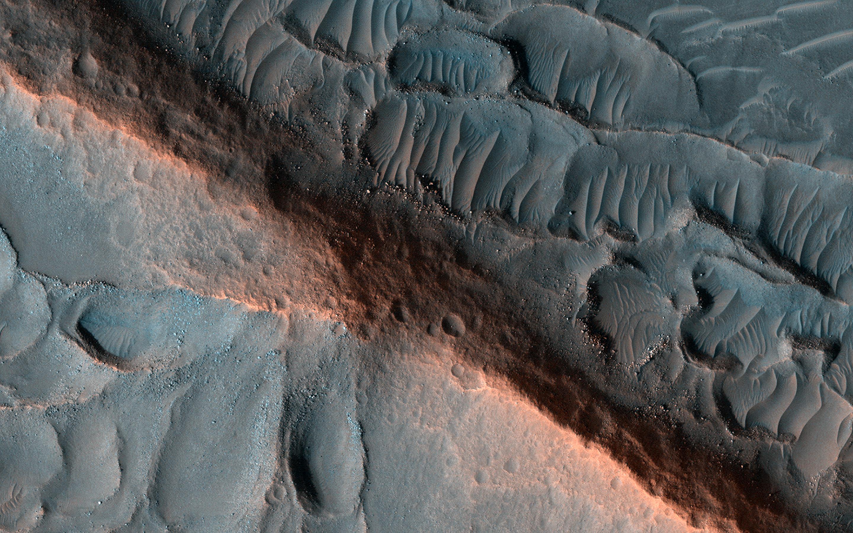 This image acquired on March 28, 2022 by NASAs Mars Reconnaissance Orbiter shows a ridge standing prominently in this scene, left behind as the surroundings were eroded, perhaps marking inverted erosion of an ancient fluvial channel.