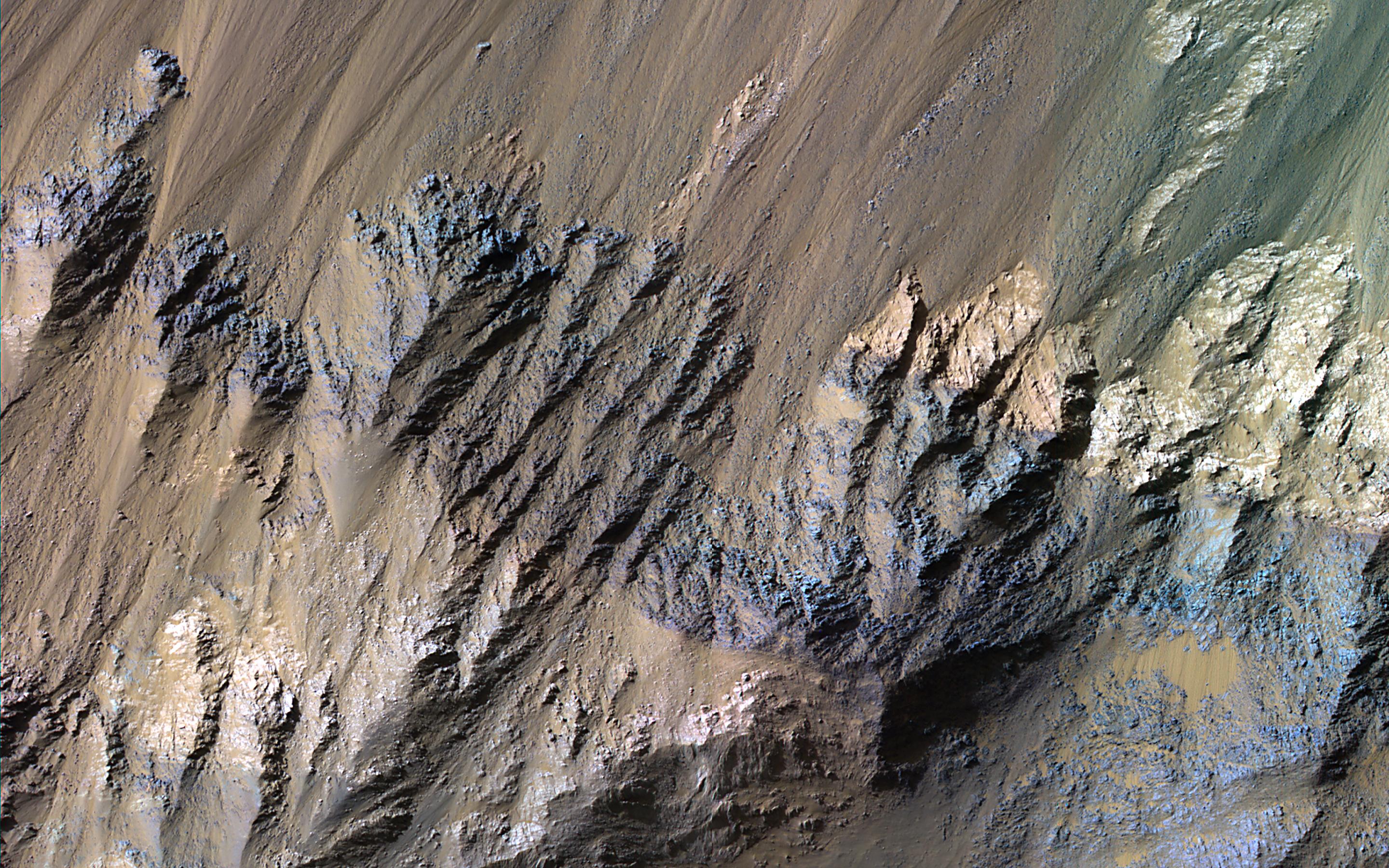 This image acquired on July 11, 2023 by NASAs Mars Reconnaissance Orbiter shows the southern wall of Coprates Chasma, in the equatorial canyon system of Valles Marineris.