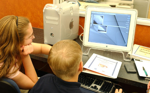 Students looking at a computer while participating in the Mars Student Imaging Project