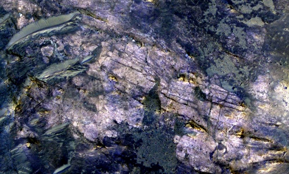 This image from orbit covers an area about 460 meters (about 1,500 feet) across, in which carbonate minerals have been identified from spectrometer observations. Fractures and possible layers are visible in the light-toned rock exposure containing the carbonates.
