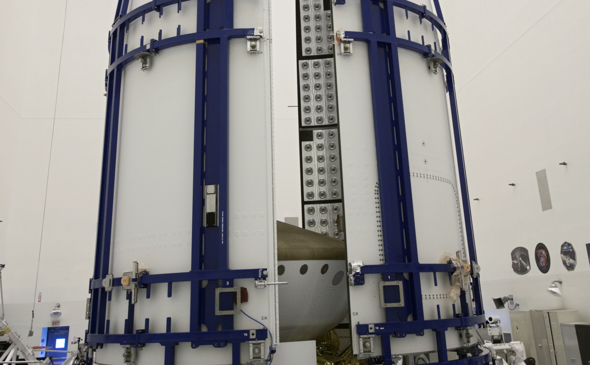 In the Payload Hazardous Servicing Facility at NASA's Kennedy Space Center in Florida, sections of an Atlas V rocket payload fairing obscure NASA's Mars Science Laboratory (MSL) from view as they close in around it.