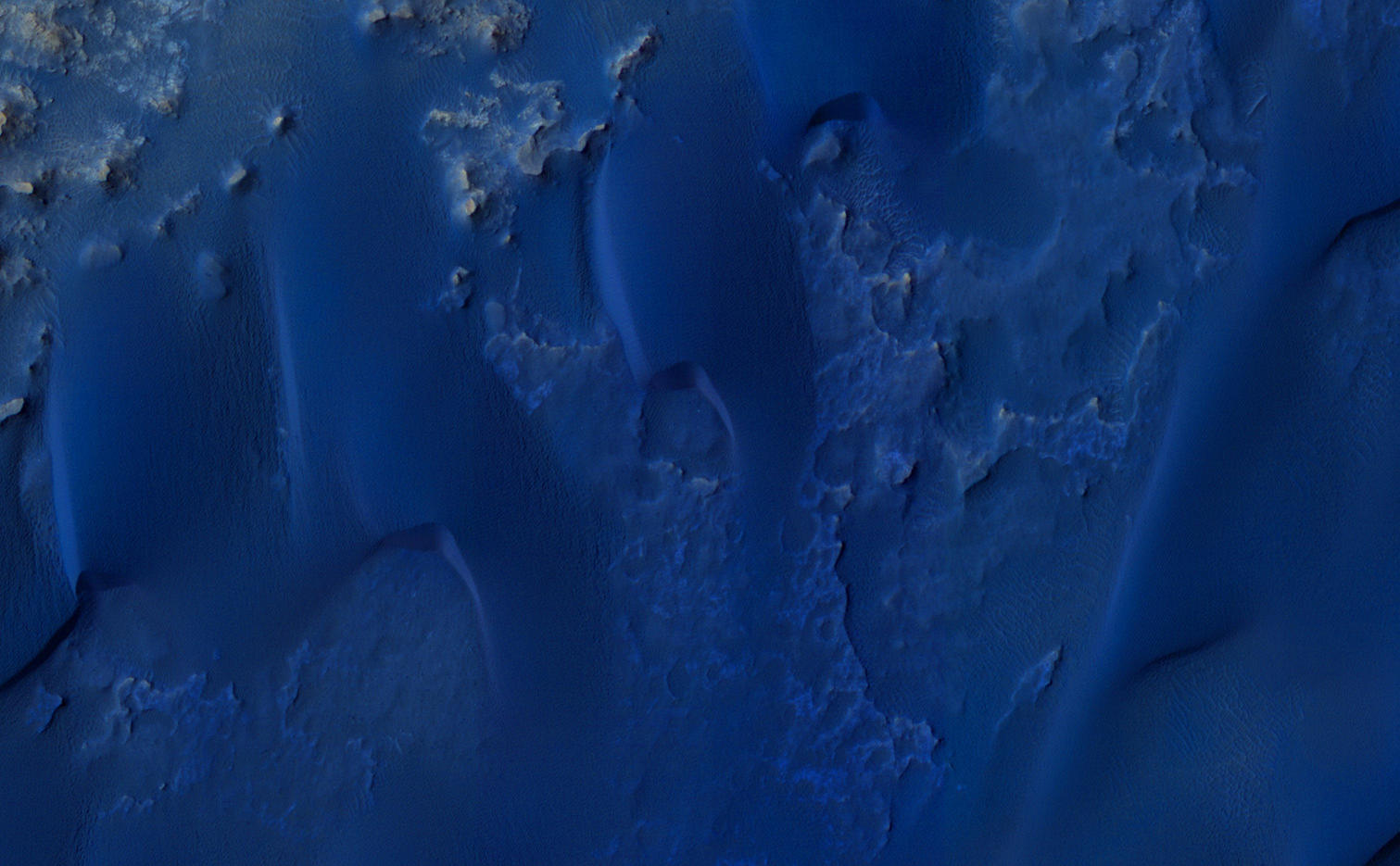 This color-enhanced view shows the terrain around the rover's landing site within Gale Crater on Mars.