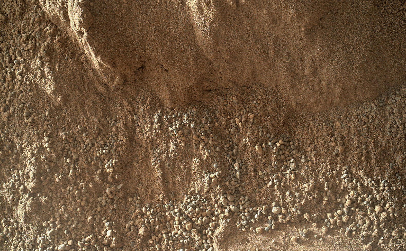 This image shows the wall of a scuffmark NASA's Curiosity made in a windblown ripple of Martian sand with its wheel.