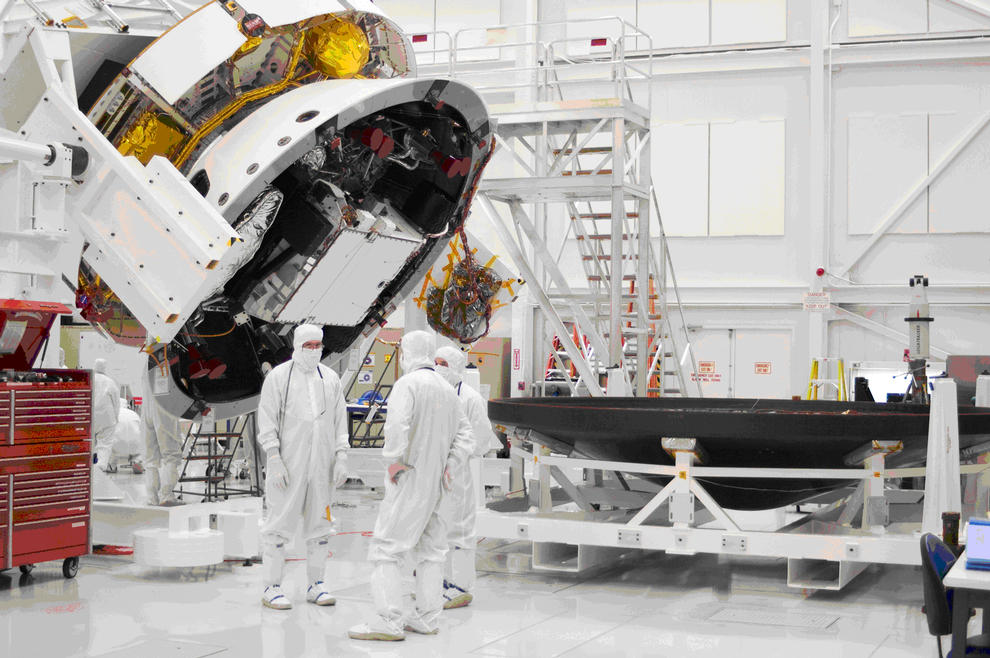 This image shows engineers standing near the rover talking.