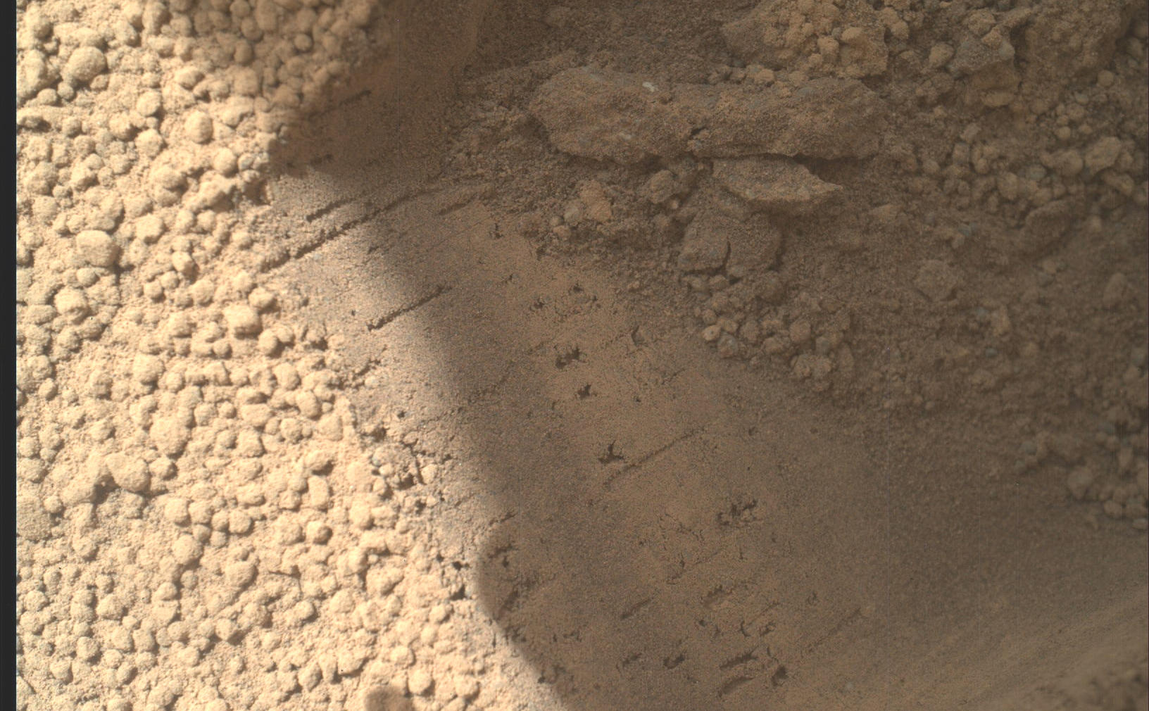 This image contributed to an interpretation by NASA's Mars rover Curiosity science team that some of the bright particles on the ground near the rover are native Martian material.
