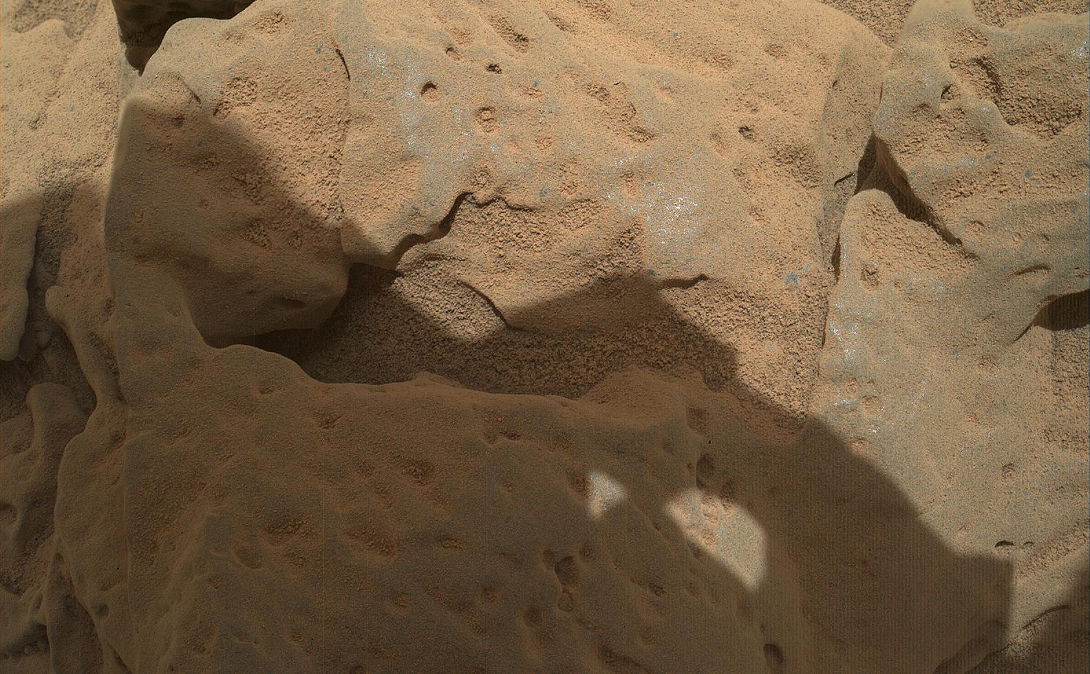 This focus-merge image from the Mars Hand Lens Imager (MAHLI) on the arm of NASA's Mars rover Curiosity shows a rock called "Burwash." The rock has a coating of dust on it. The coarser, visible grains are windblown sand.