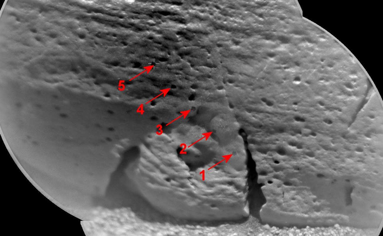 This view of a rock called "Rocknest 3" combines two images taken by the Chemistry and Camera (ChemCam) instrument on the NASA Mars rover Curiosity and indicates five spots where ChemCam had hit the rock with laser pulses to check its composition.