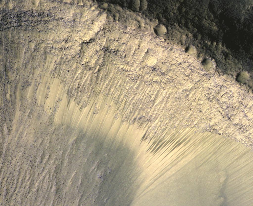 These images from the High Resolution Imaging Science Experiment (HiRISE) camera on NASA's Mars Reconnaissance Orbiter show how the appearance of dark markings on Martian slope changes with the seasons.