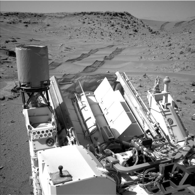 ASA's Curiosity Mars rover used the Navigation Camera (Navcam) on its mast to catch this look-back eastward at wheel tracks from driving through and past "Dingo Gap" inside Gale Crater.