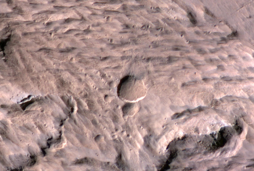 The largest crater associated with a March 2012 impact on Mars has many smaller craters around it, revealed in this image from the High Resolution Imaging Science Experiment (HiRISE) camera on NASA's Mars Reconnaissance Orbiter.