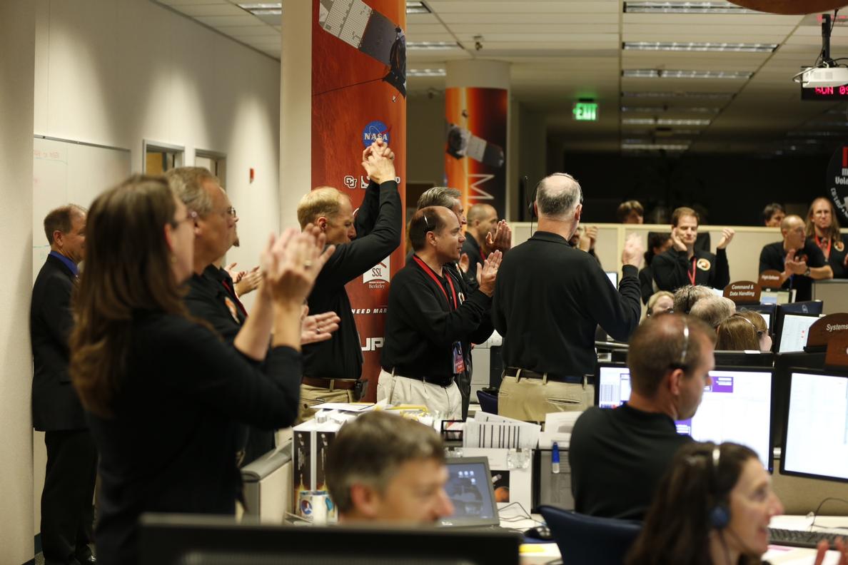 This image shows about 20 people wearing black shirts and mic headset clapping to celebrate MAVEN's arrival at Mars.
