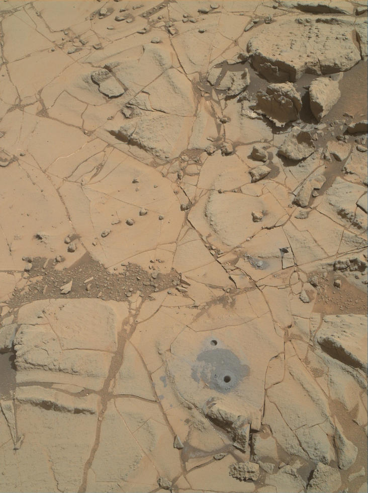Gray cuttings from Curiosity's drilling into a target called "Mohave 2" are visible surrounding the sample-collection hole in this Jan. 31, 2015, image from the rover's MAHLI camera. This site in the "Pahrump Hills" outcrop provided the mission's second drilled sample of Mars' Mount Sharp.