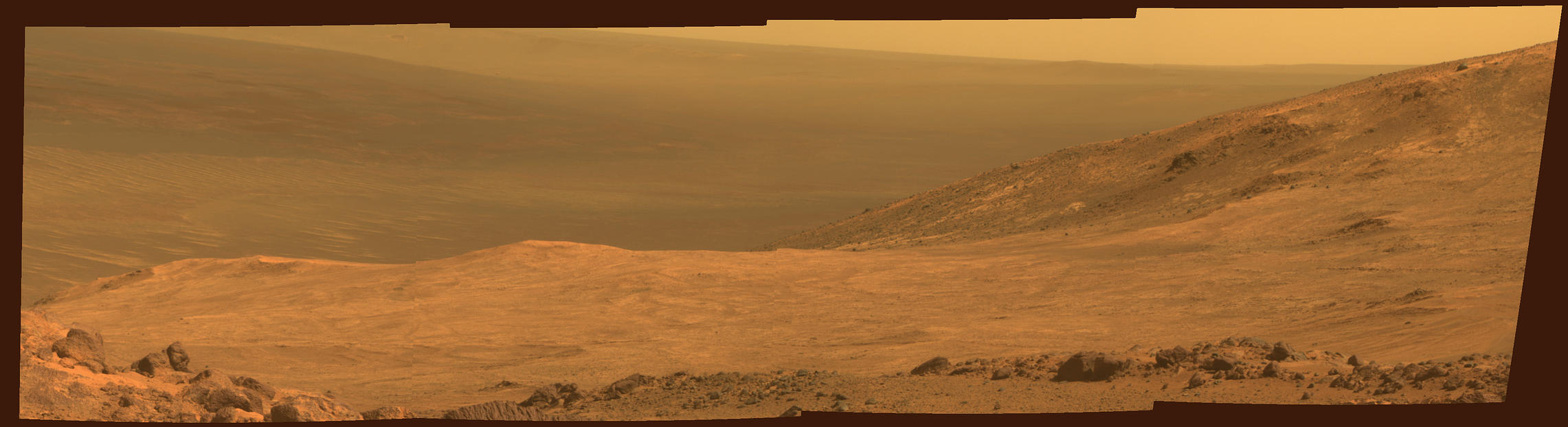 This view from NASA's Opportunity Mars rover shows part of "Marathon Valley," a destination on the western rim of Endeavour Crater, as seen from an overlook north of the valley. It was taken by the rover's Pancam on March 13, 2015. This version is in approximate true color.