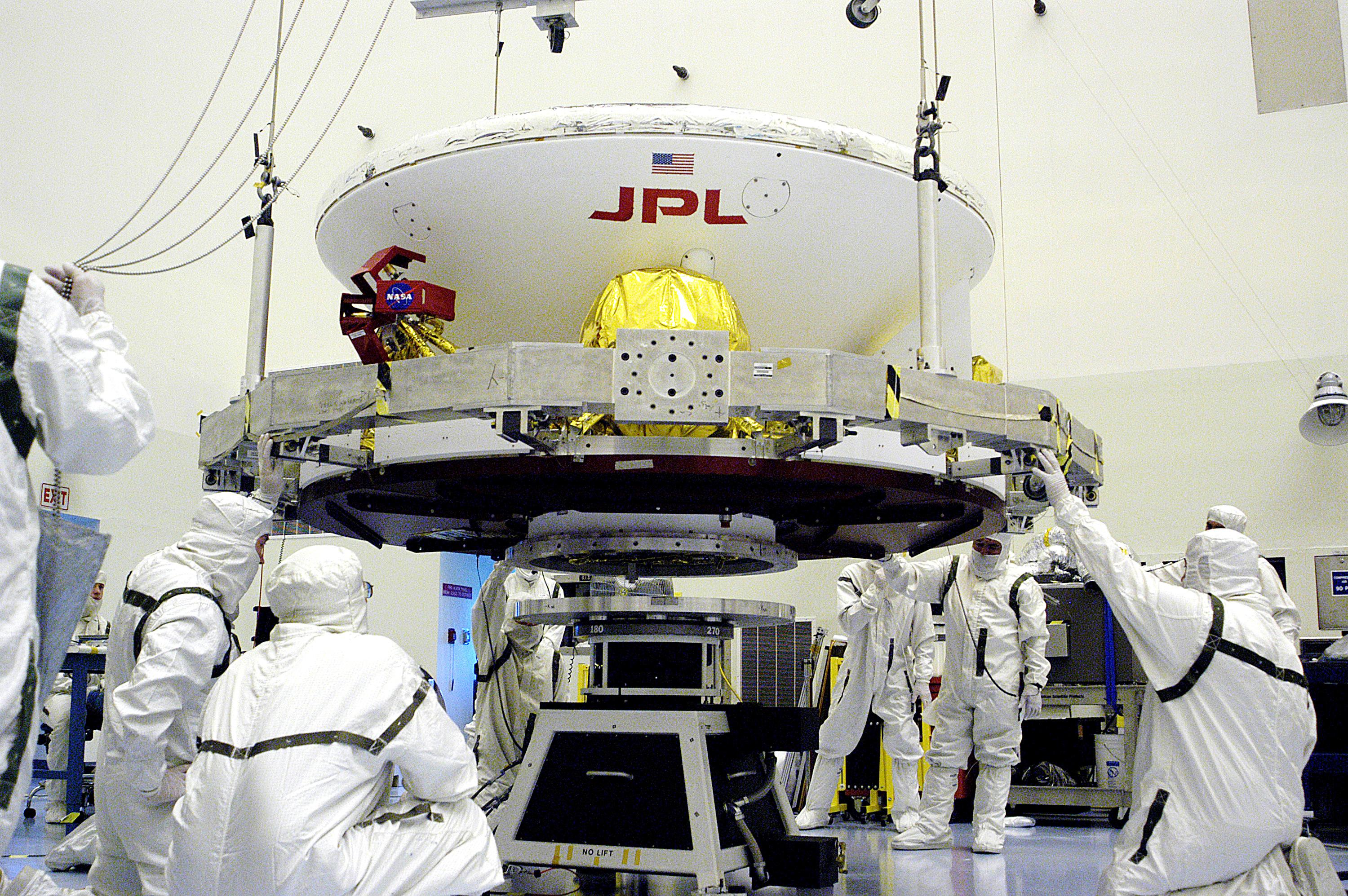 In the Payload Hazardous Servicing Facility, workers prepare to lift the Mars Exploration Rover-1 (MER-B) onto a spin table during preflight processing of the spacecraft.