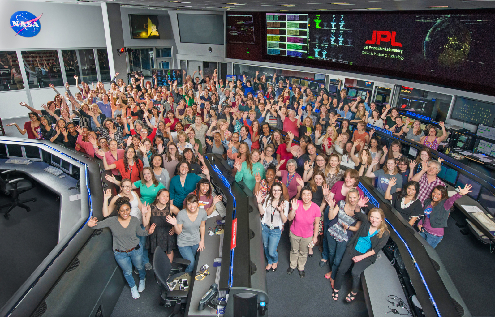 Women working in science, technology, engineering and mathematics at NASA's Jet Propulsion Laboratory pose for a photo in mission control in honor of Women in Science Day.