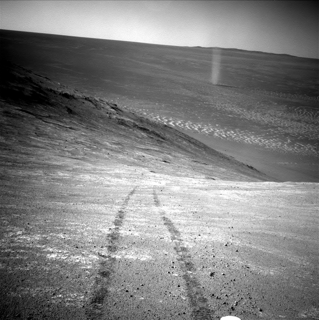 From its perch high on a ridge, NASA's Mars Exploration Rover Opportunity recorded this image of a Martian dust devil twisting through the valley below.