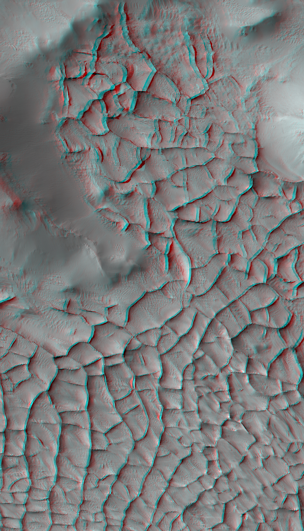 This stereo view shows an area on Mars where narrow rock ridges intersect at angles forming corners of polygons. It combines two observations from the HiRISE camera on NASA's Mars Reconnaissance Orbiter and appears three-dimensional when viewed through red-blue glasses with the red lens on the left.