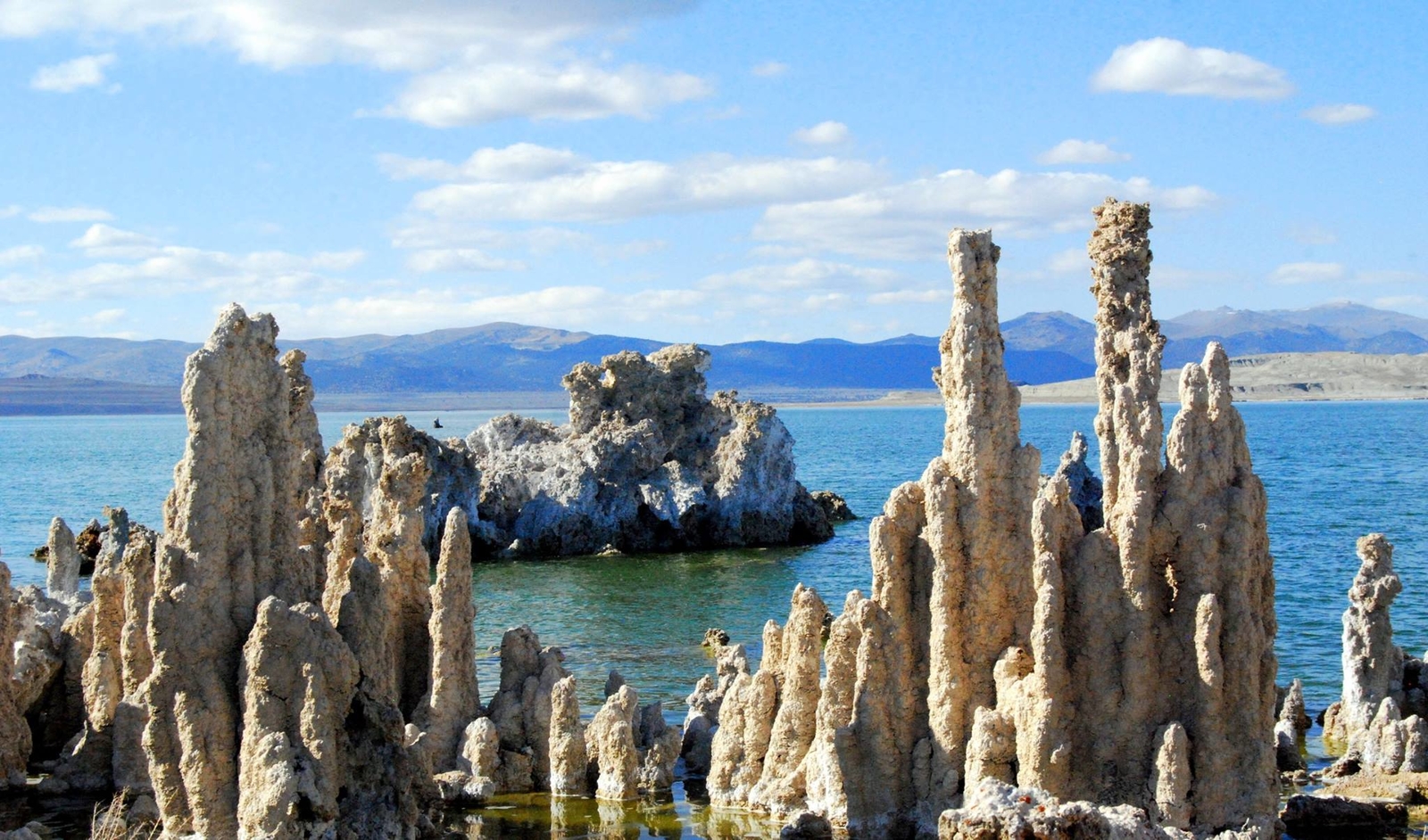 Mono Lake, California, with salt pillars known as "tufas" visible. JPL scientists tested new methods for detecting chemical signatures of life in the salty waters here, believing them to be analogs for water on Mars or ocean worlds like Europa.