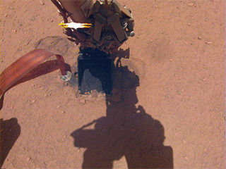 In this image from Oct. 26, 2019 — the 325th Martian day, or sol, of the mission — InSight's heat probe, or "mole," is seen after backing about halfway out of the hole it had burrowed.