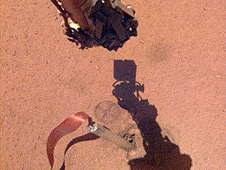 The shadow of NASA InSight's robotic arm moves over its heat probe, or "mole," on Nov. 3, 2019, the 333rd Martian day, or sol, of the mission.